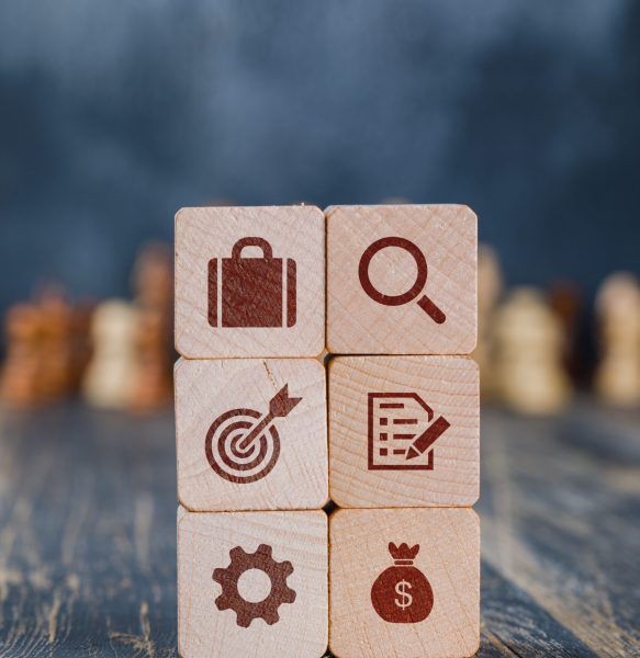 Business strategy concept with wooden cubes, chess figures on gloomy and wooden background side view.